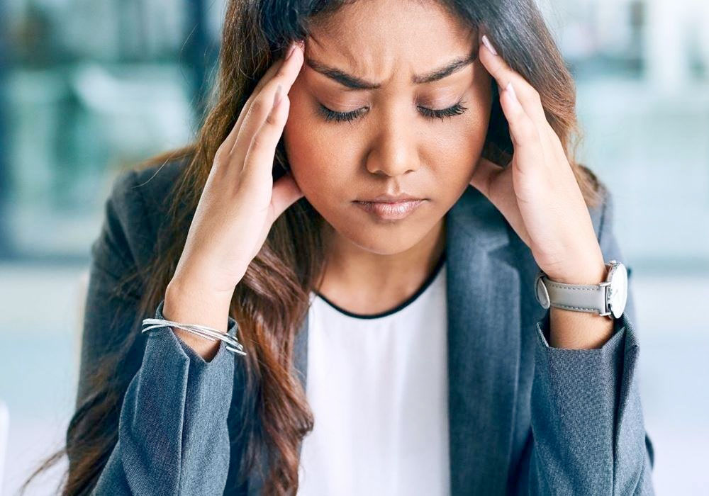 office employee suffering from a stress headache