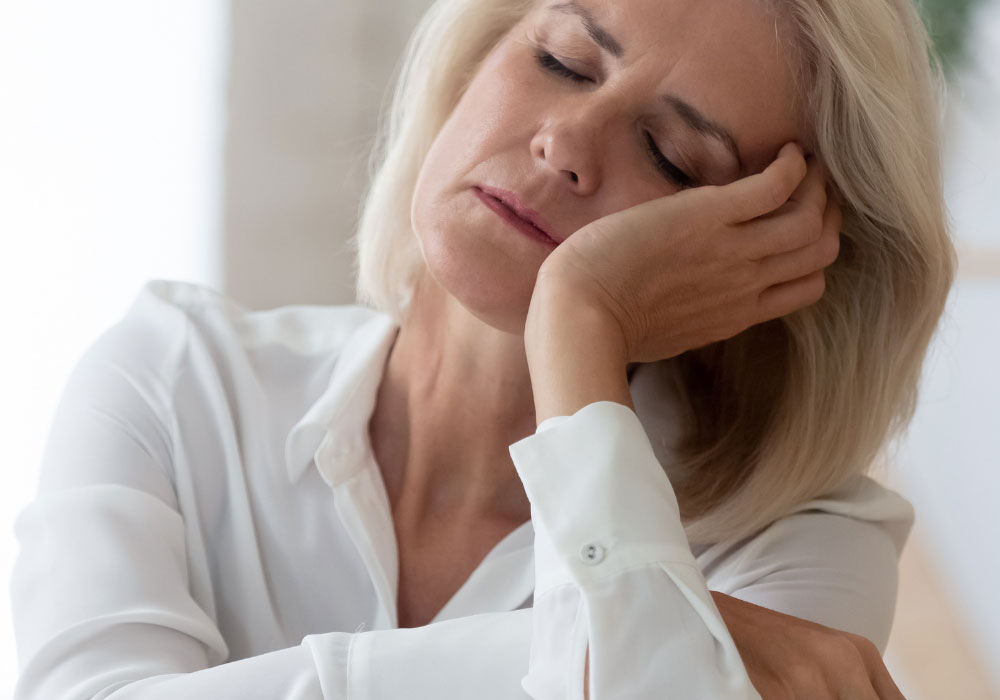 female employee suffering from symptoms of menopause