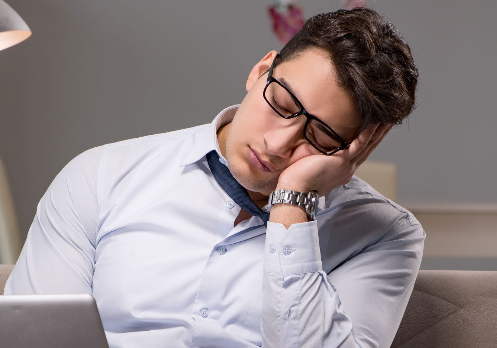 office worker falling asleep at desk