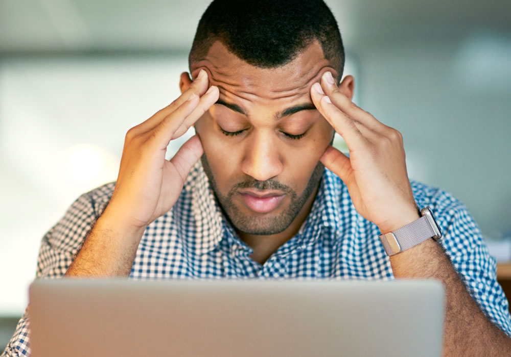 burnt out team member in front of computer