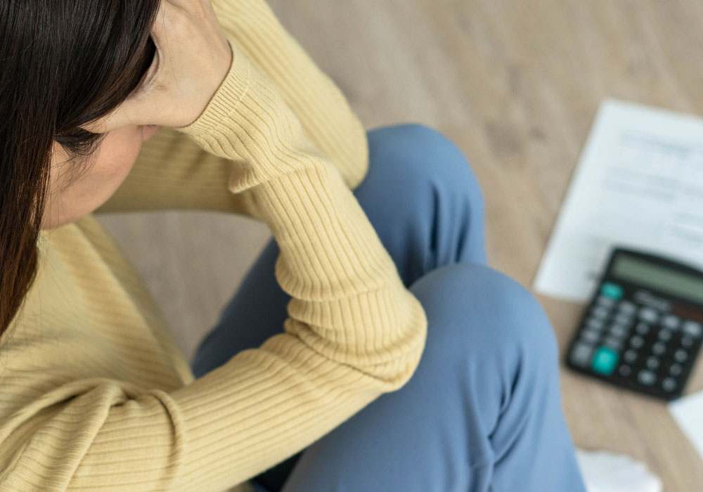 woman suffering from the effects of financial stress