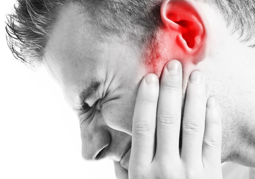 man suffering the effects of tinnitus