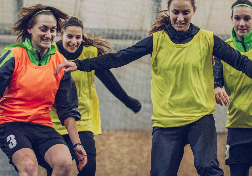 female football players training on the pitch