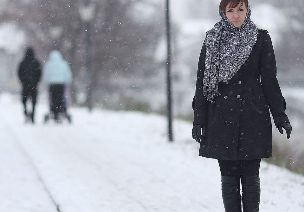 woman walking along a pavement in winter